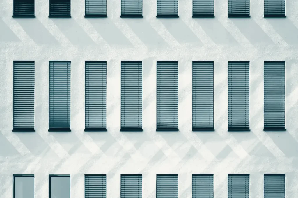 A white facade with closed window shutters